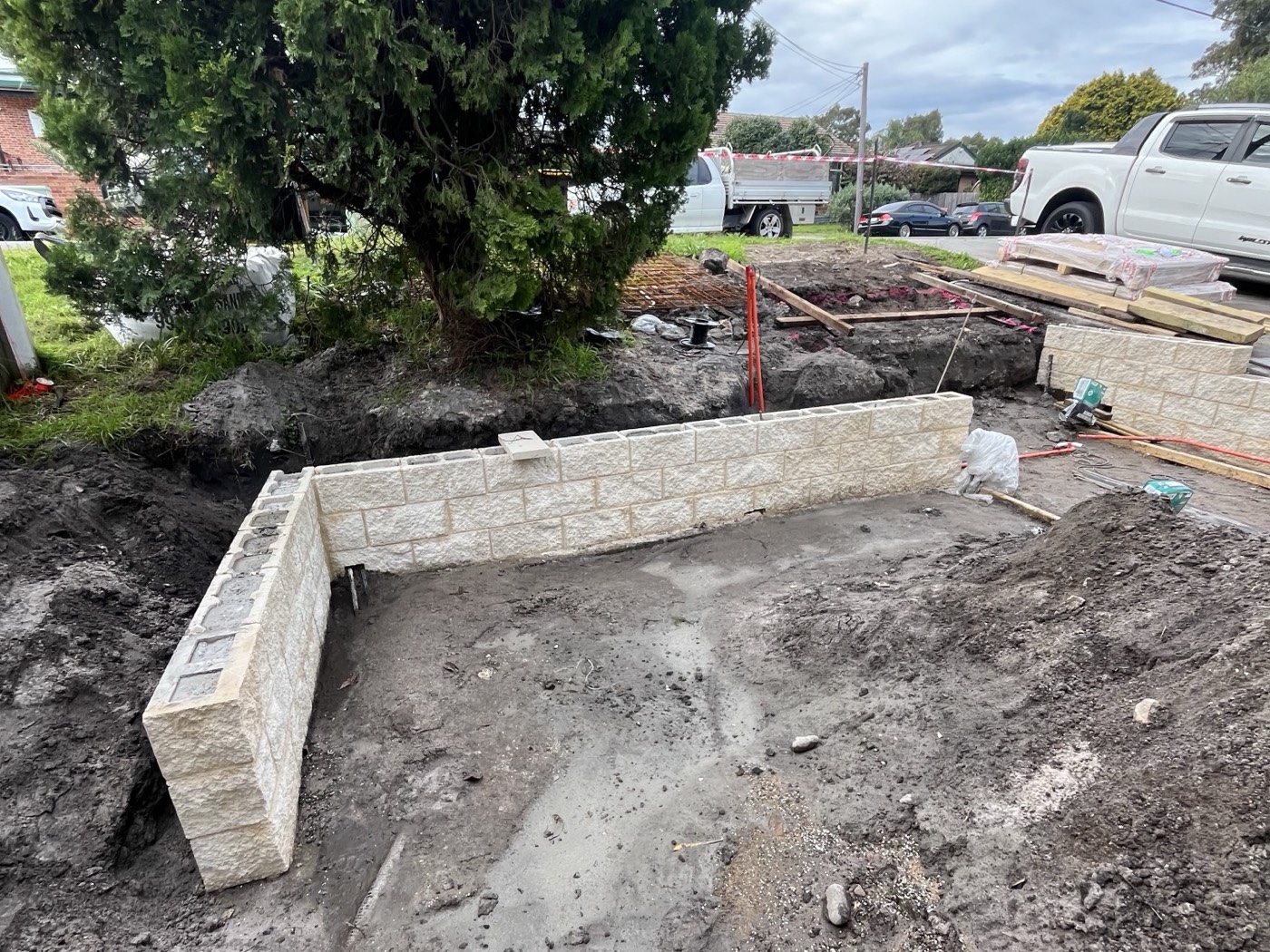 Before: bare dirt and a half-built block retaining wall